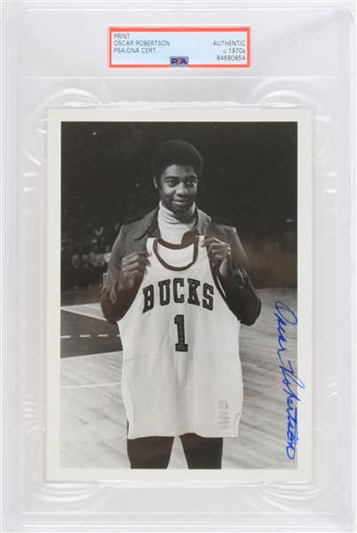 1970 circa Oscar Robertson Milwaukee Bucks Signed 5x7 Print (PSA/DNA Slabbed) "Holding Sand Knit Jersey"